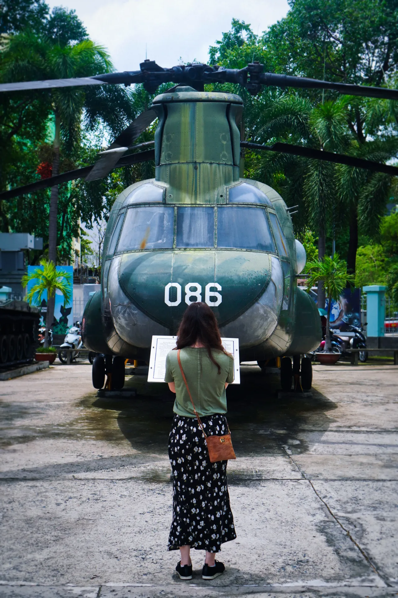 Woman Standing in Front of An Abandoned CH-47 Chinook Helicopter at the War Remnants Museum